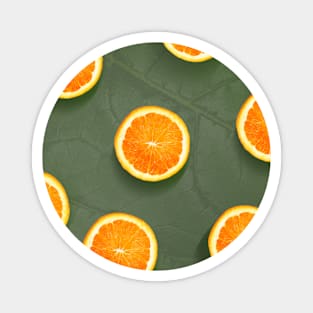 Oranges slices pattern background, fresh fruits on green background Magnet